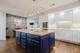 This spacious kitchen called for a perfect finish to highlight its standout details.  Brushworks' premium cabinet painting work enhances the beautiful rich wood and natural stone throughout the space.